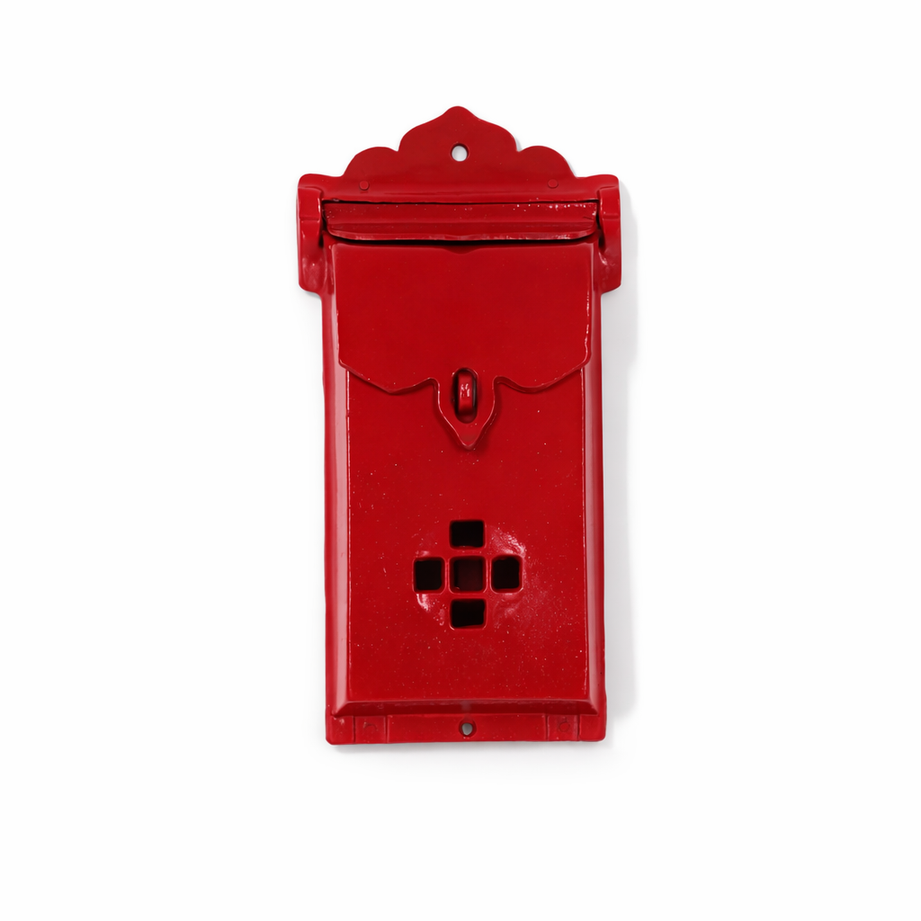 Red mailbox with decorative top on a white background