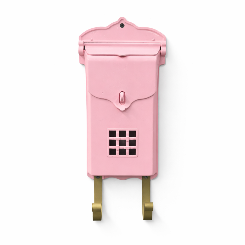 Pink mailbox with gold hooks on a white background