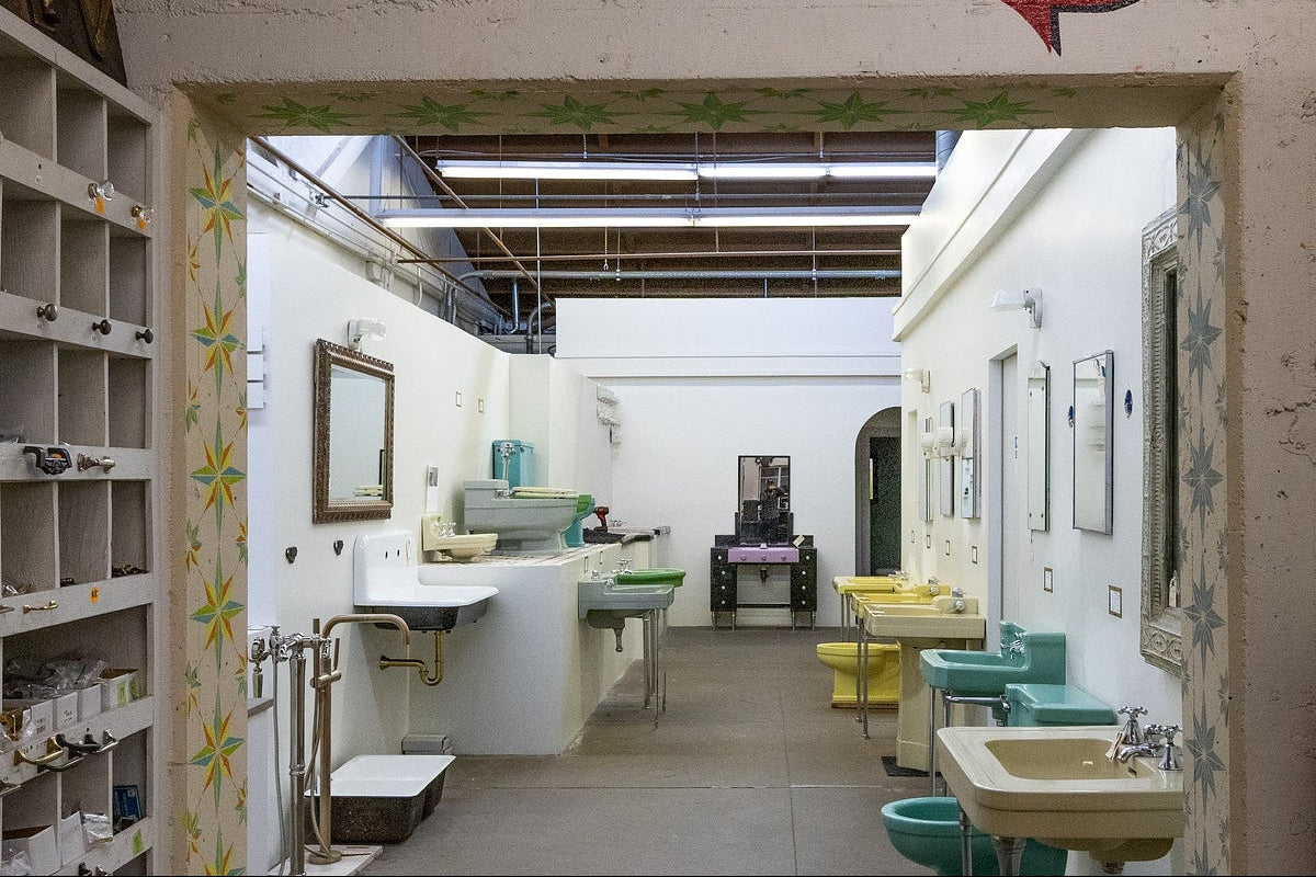 Entrance to a plumbing workshop with sinks and tools.