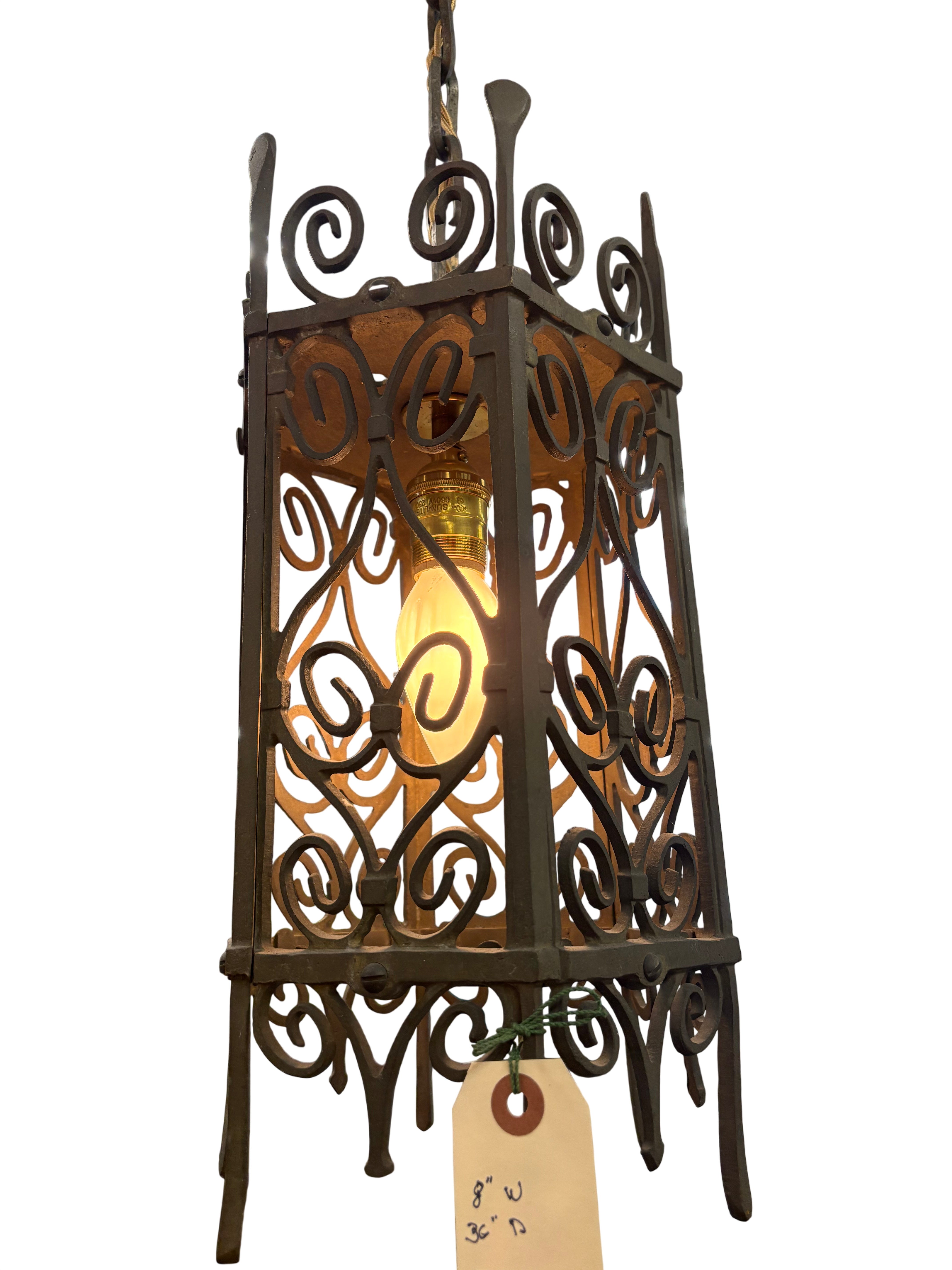 Decorative hanging lantern with intricate metalwork in a warehouse setting