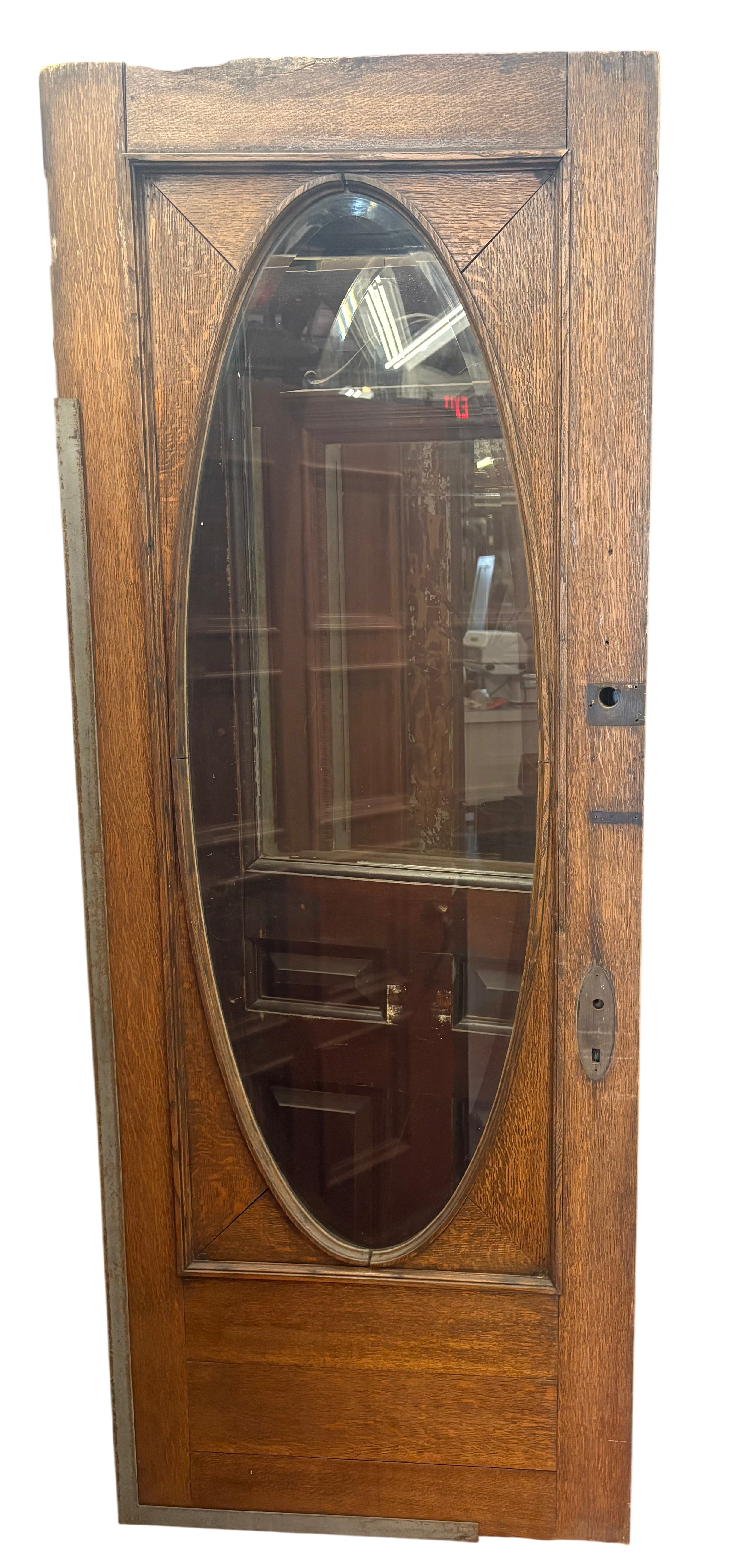 Wooden door with an oval glass panel in a warehouse setting