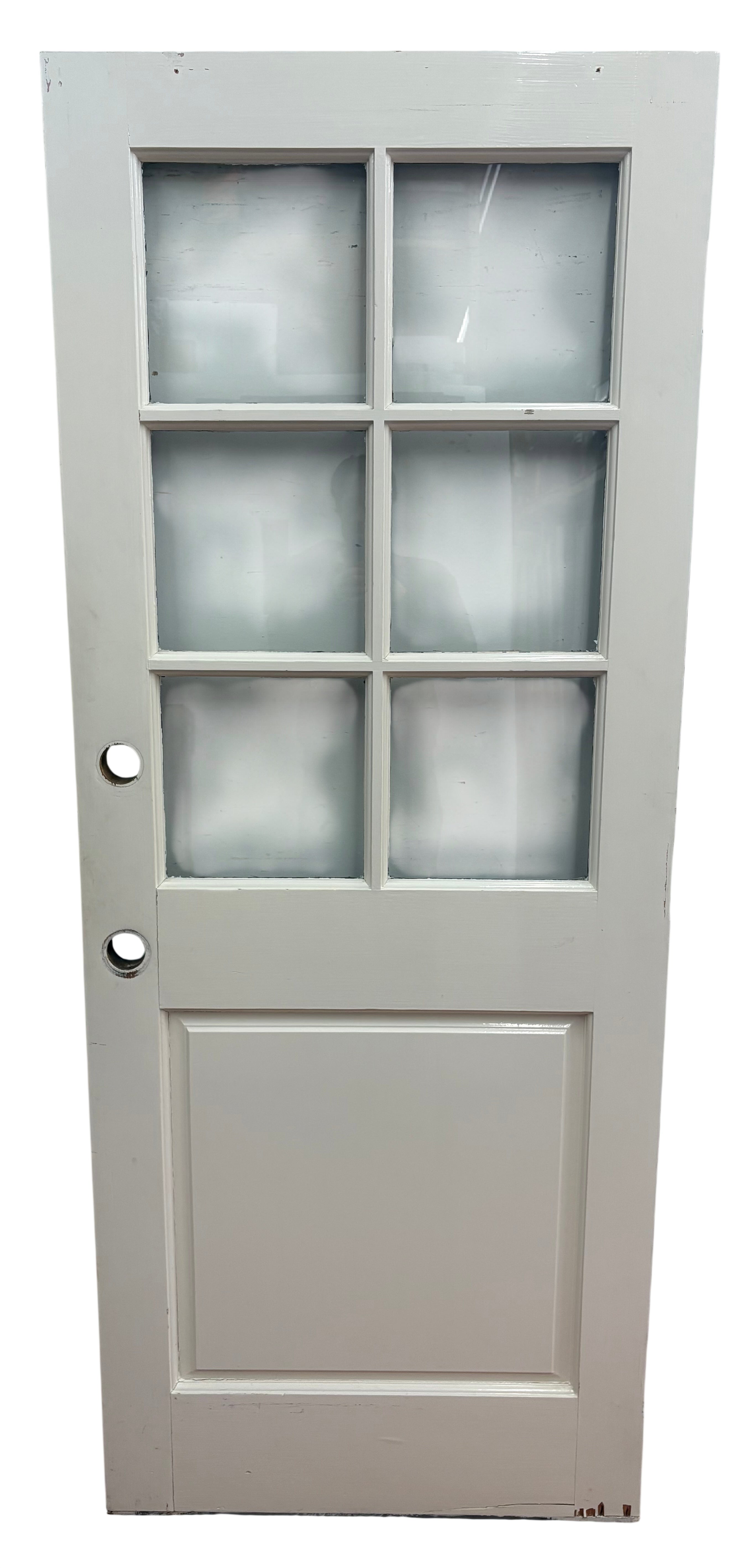 White door with glass panels and black handles on a plain background