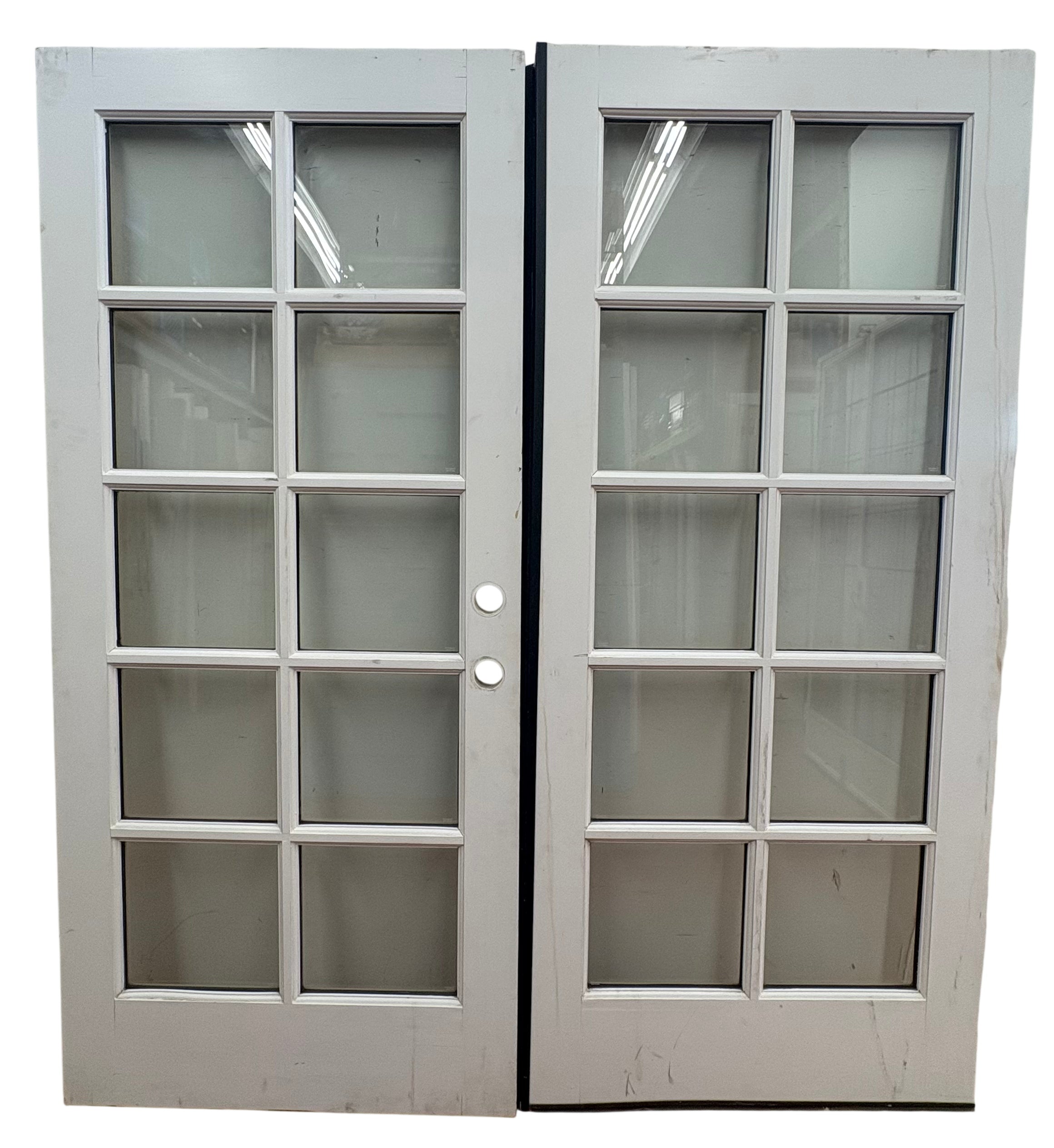 Pair of white French doors with glass panels on a white background