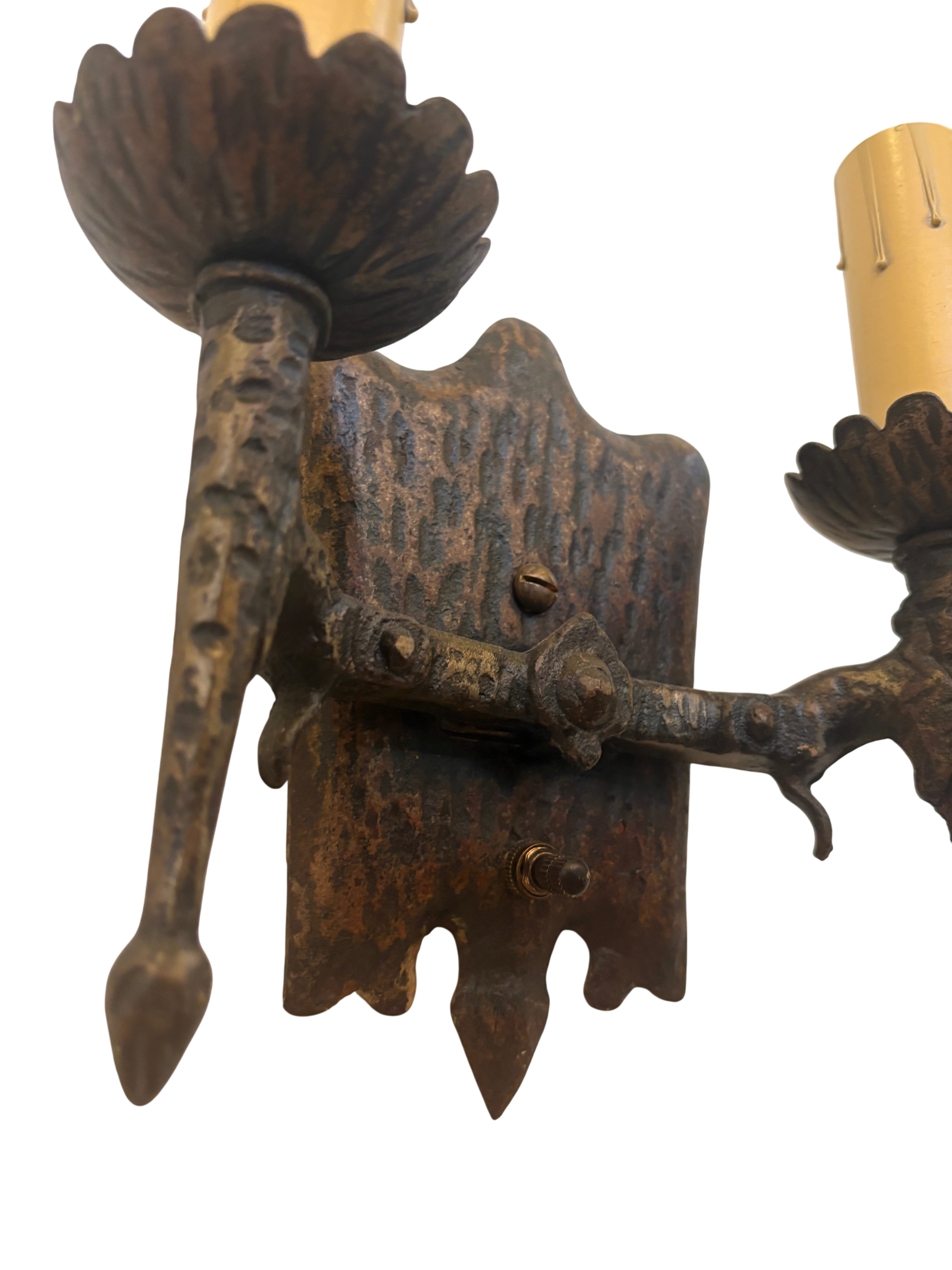 Decorative wall sconce with intricate metalwork on a white background