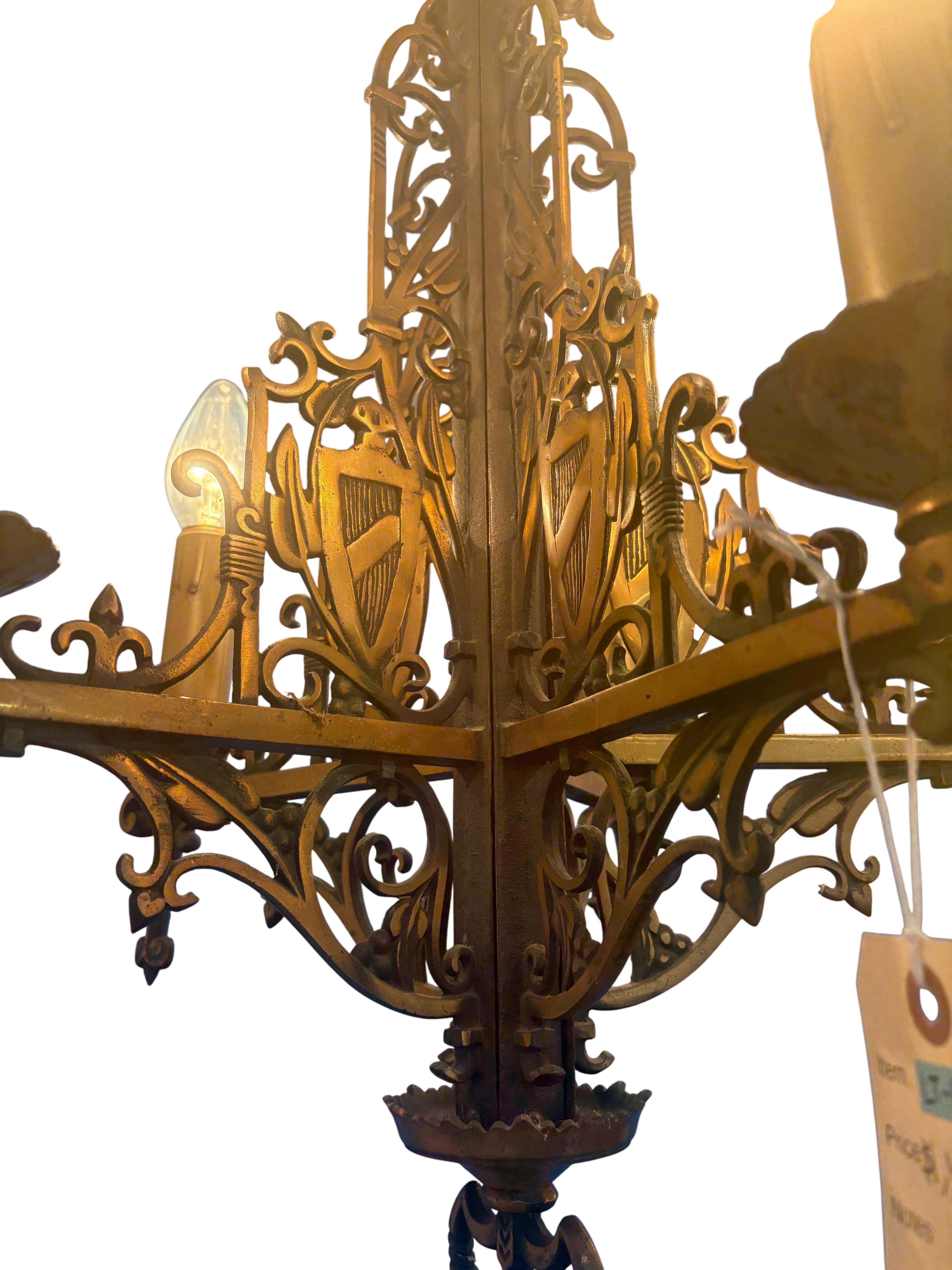 Gold chandelier with intricate designs on a white background