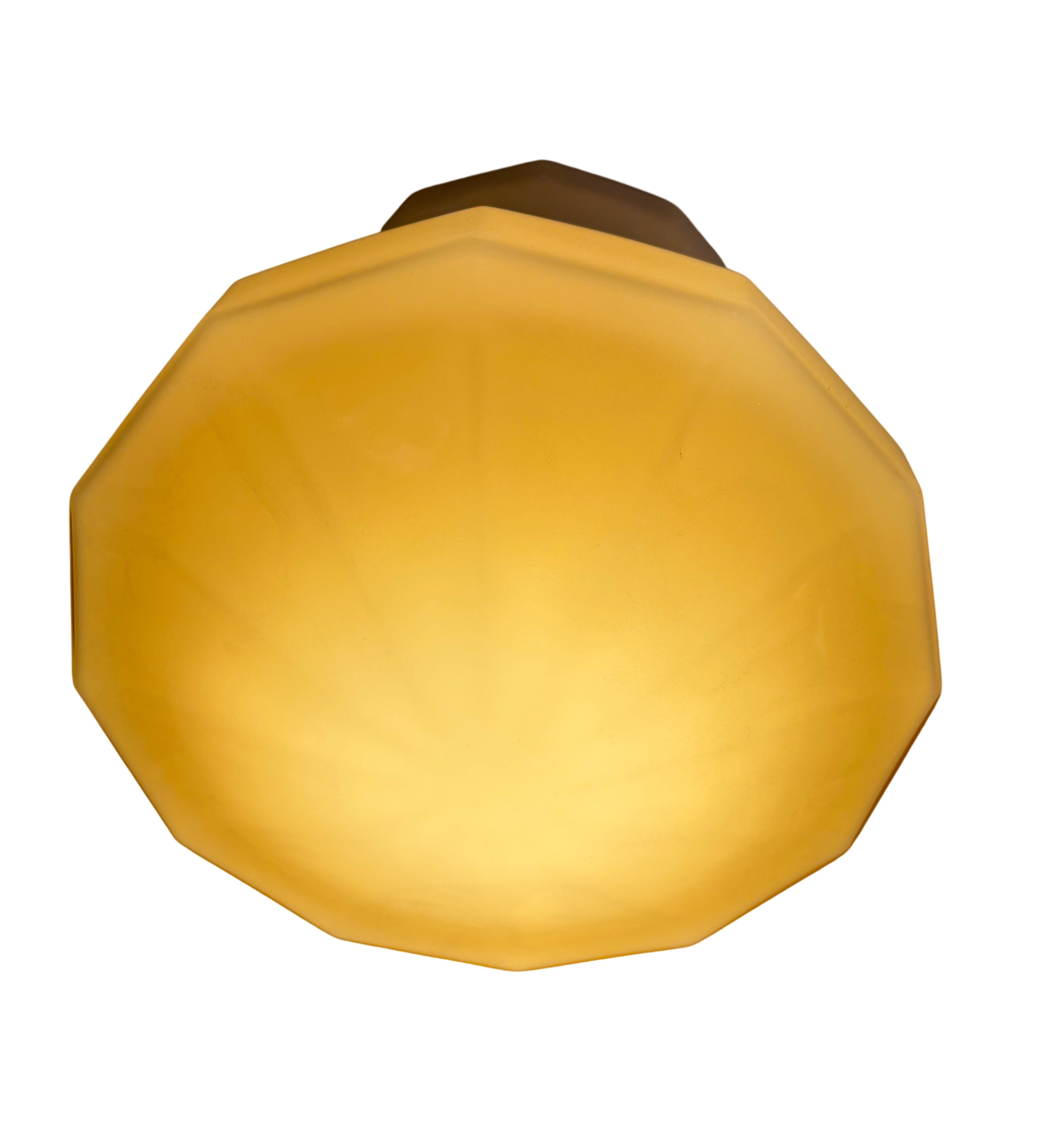 Yellow octagonal light fixture on a white background