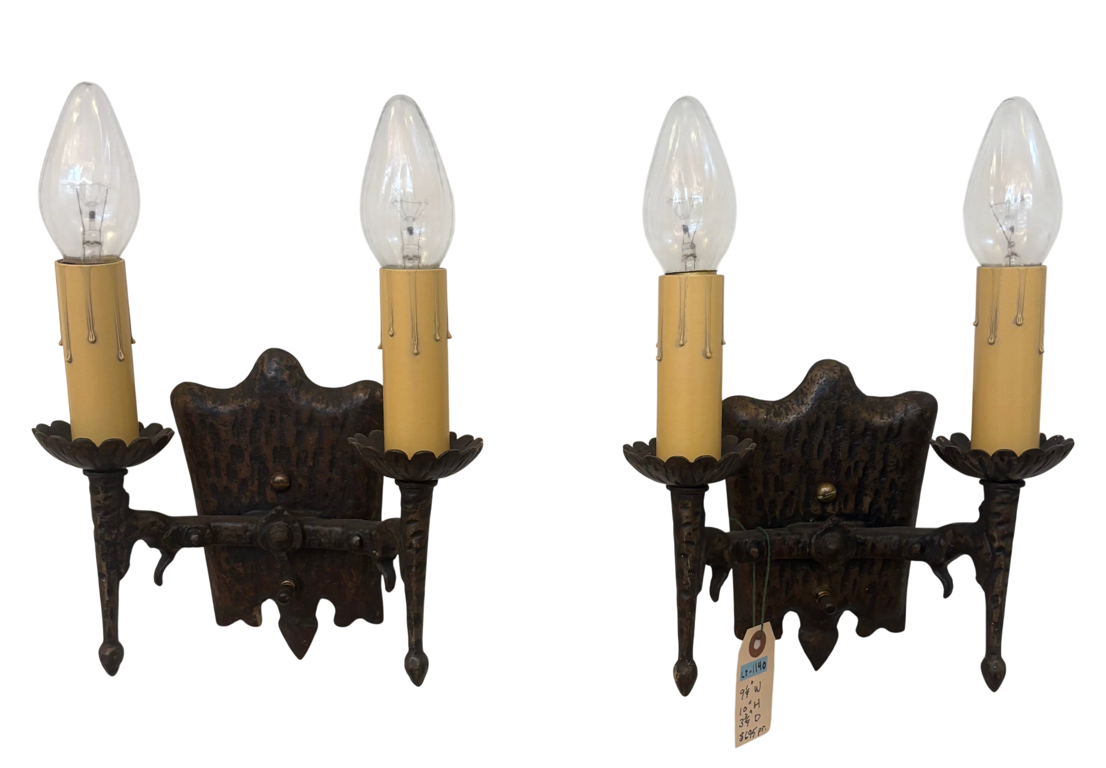 Pair of vintage-style wall sconces with dark metal frames and clear light bulbs on a white background.
