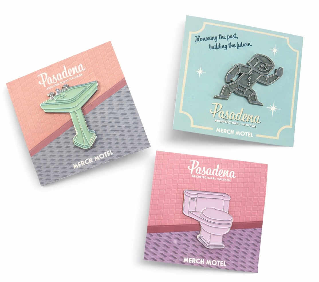 Three enamel pins on display with 'Pasadena Merch Motel' branding.