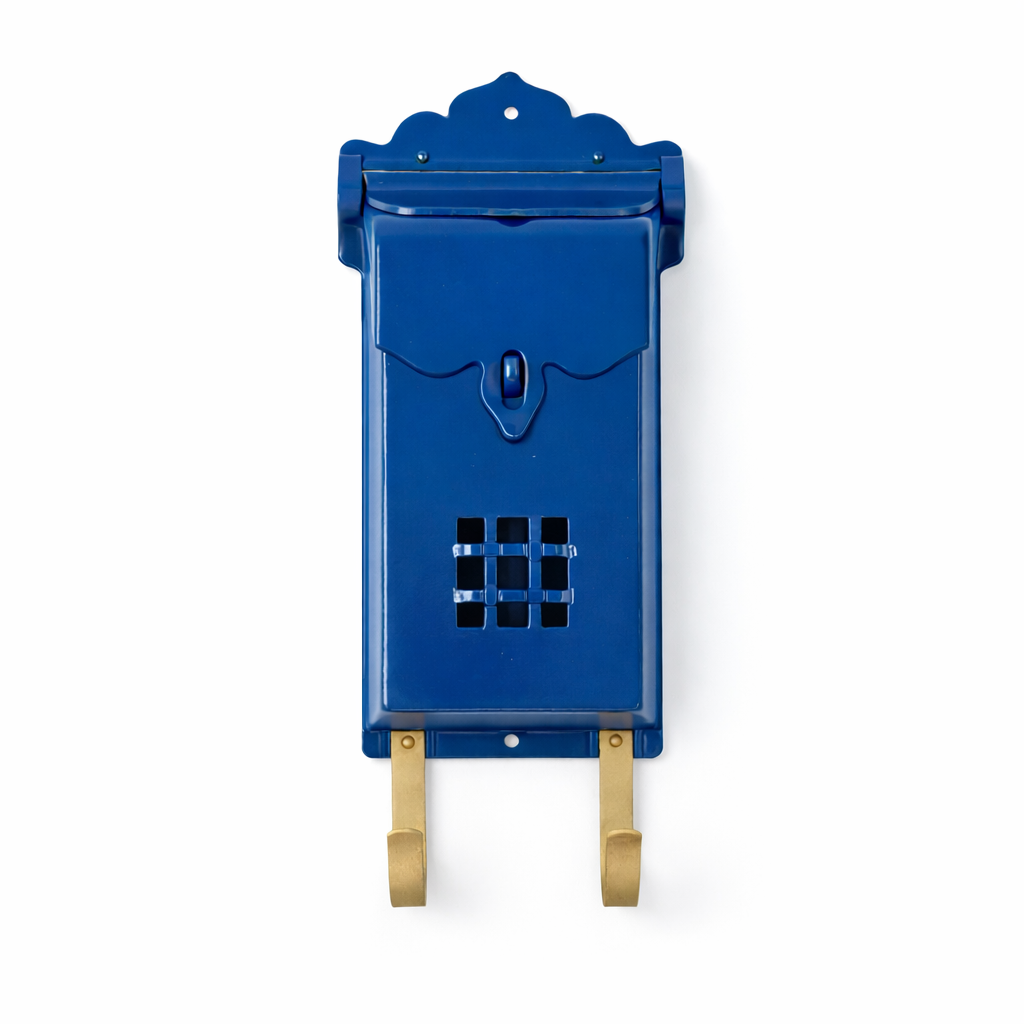 Blue wall-mounted mailbox with decorative top on a white background