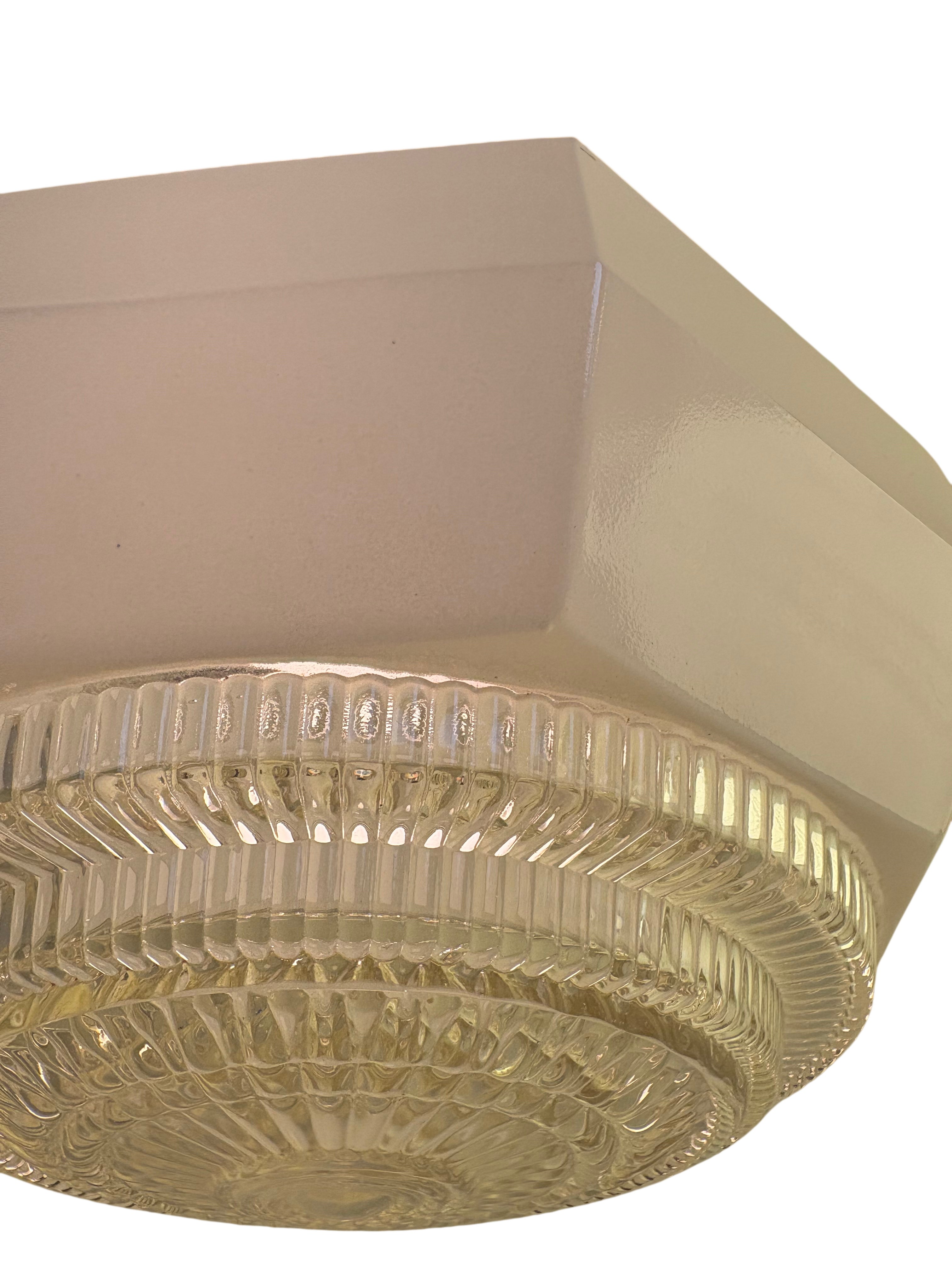 Ceiling light fixture with textured glass shade on a white background