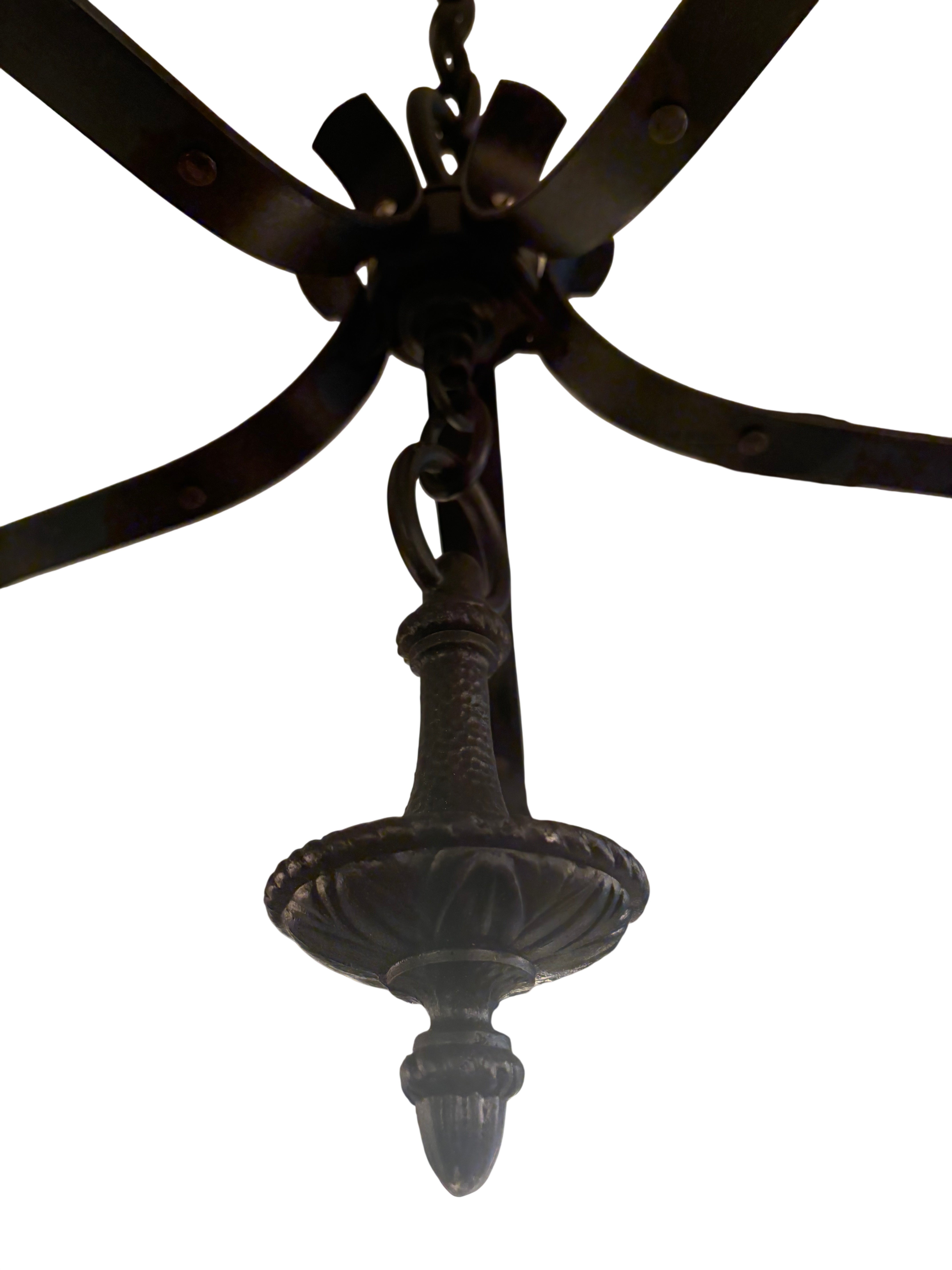 Spanish Revival style chandelier with hand-worked iron frame and milk glass globe shades, 1920s–1930s.Chandelier (LT- 1117)