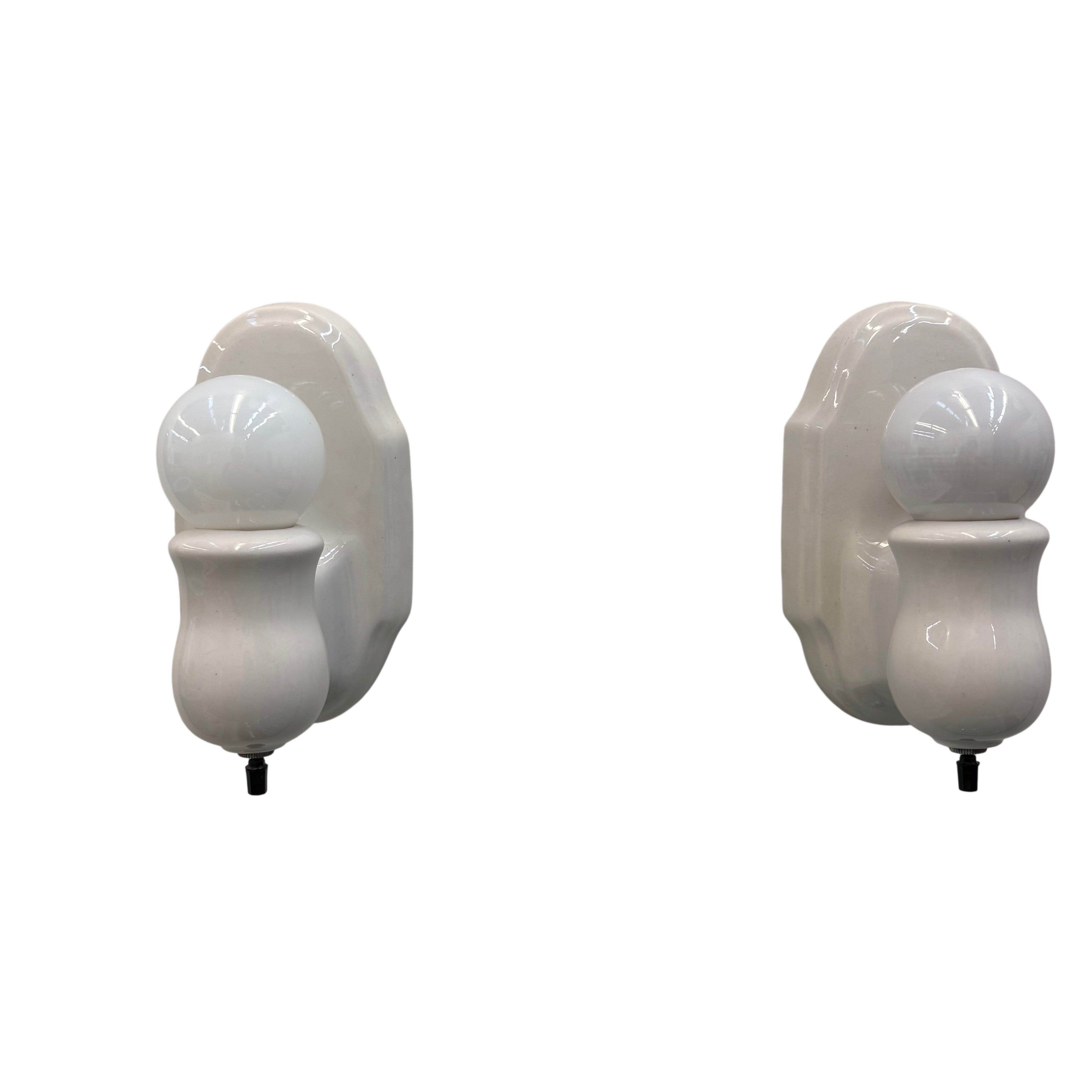 Two beige wall-mounted light fixtures on a white background