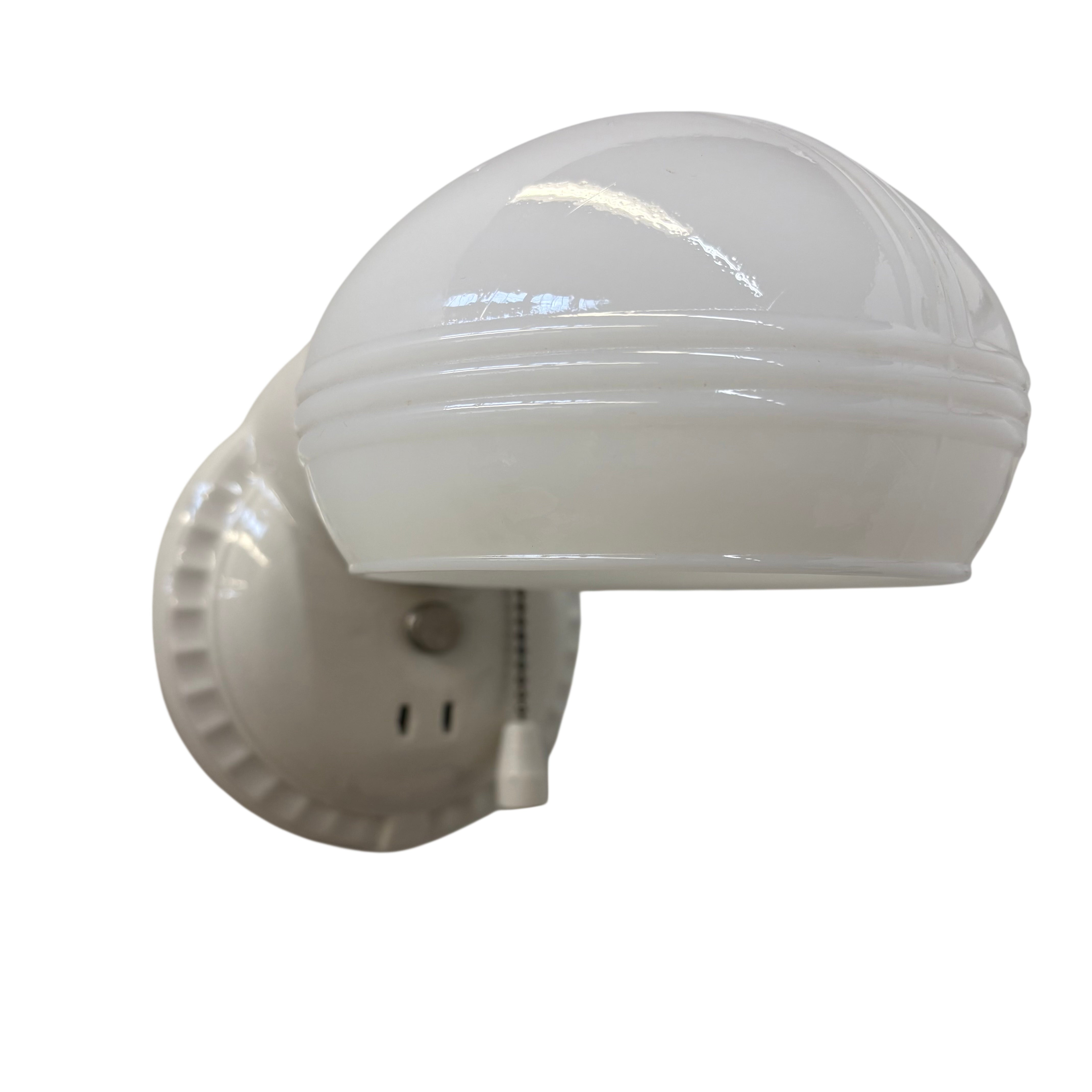 White wall-mounted light fixture on a white background