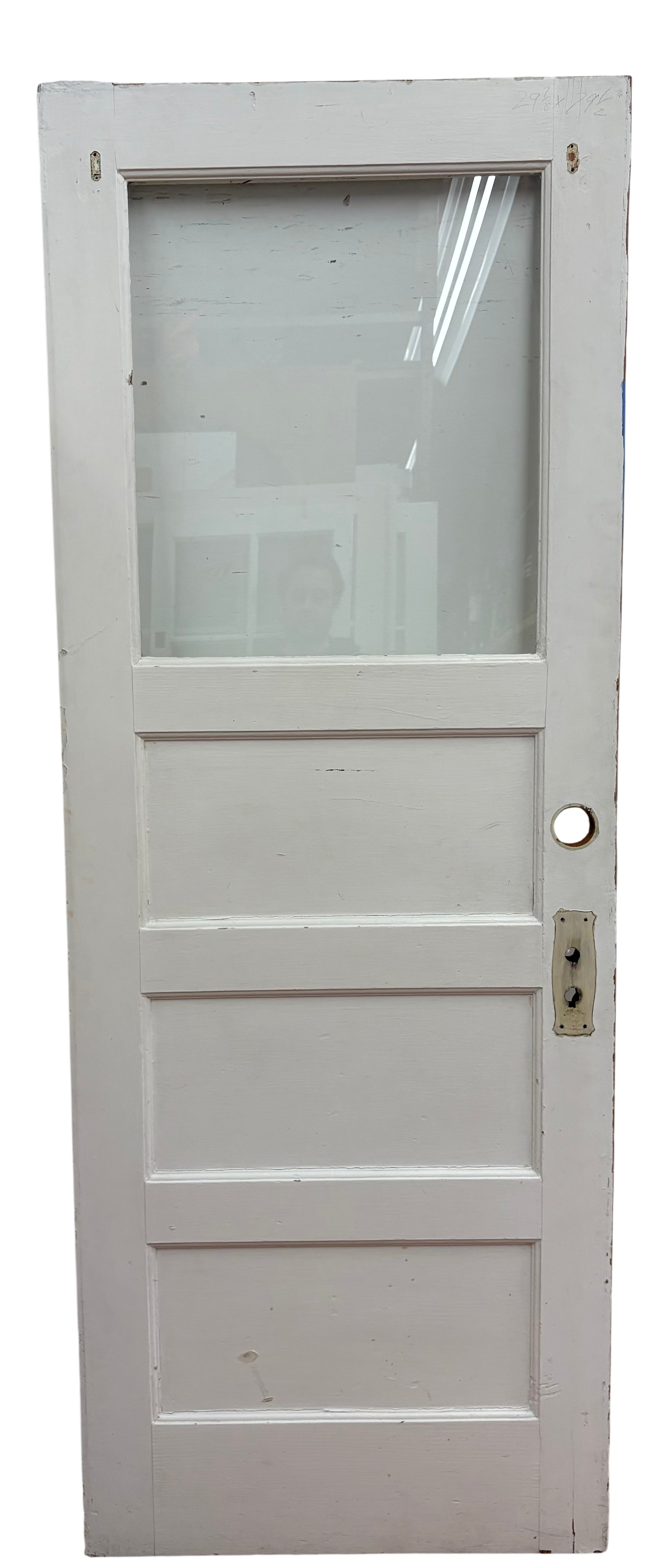 White wooden door with glass panel on a white wall