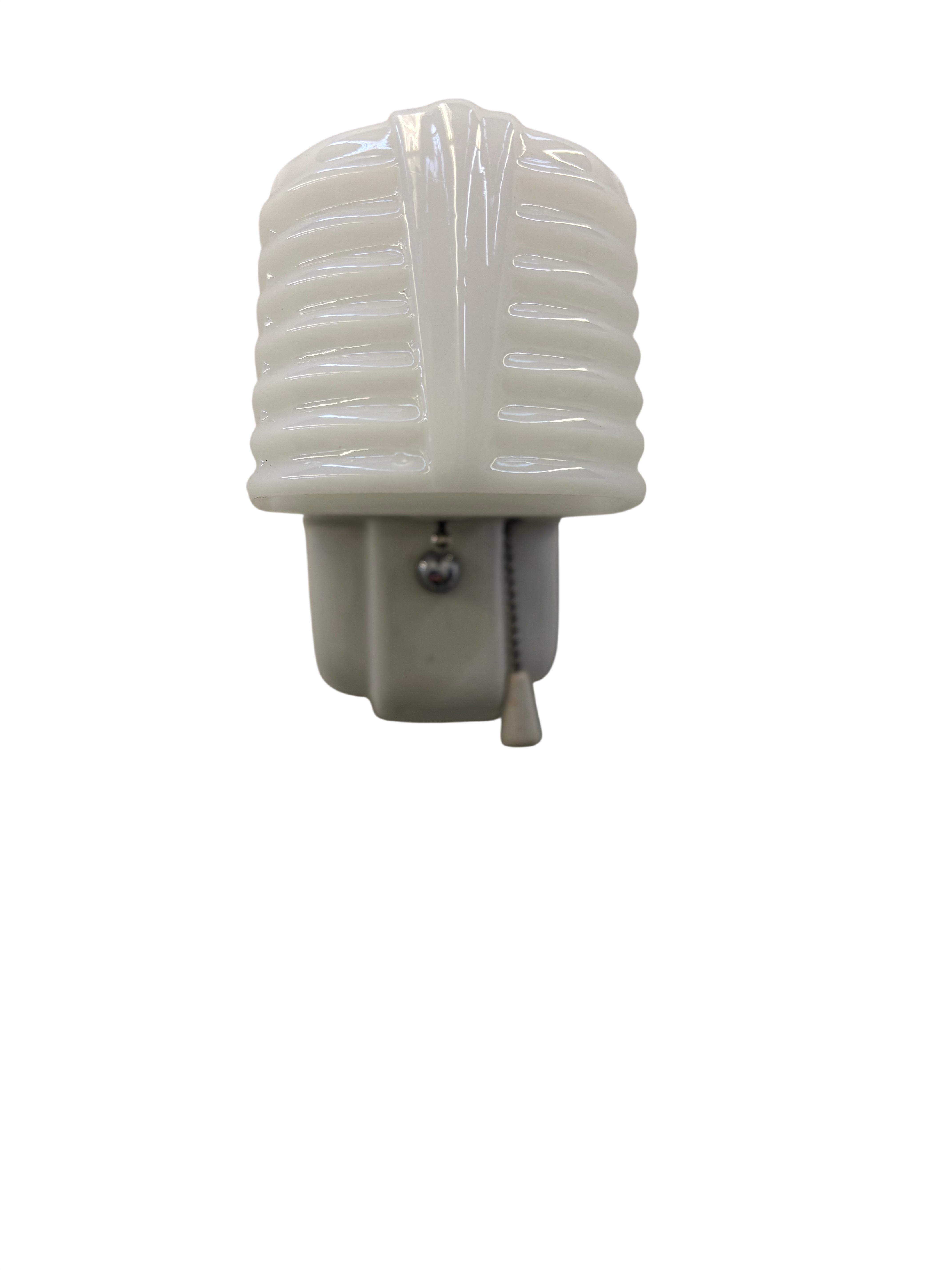White porcelain ribbed shaded sconce on a white background