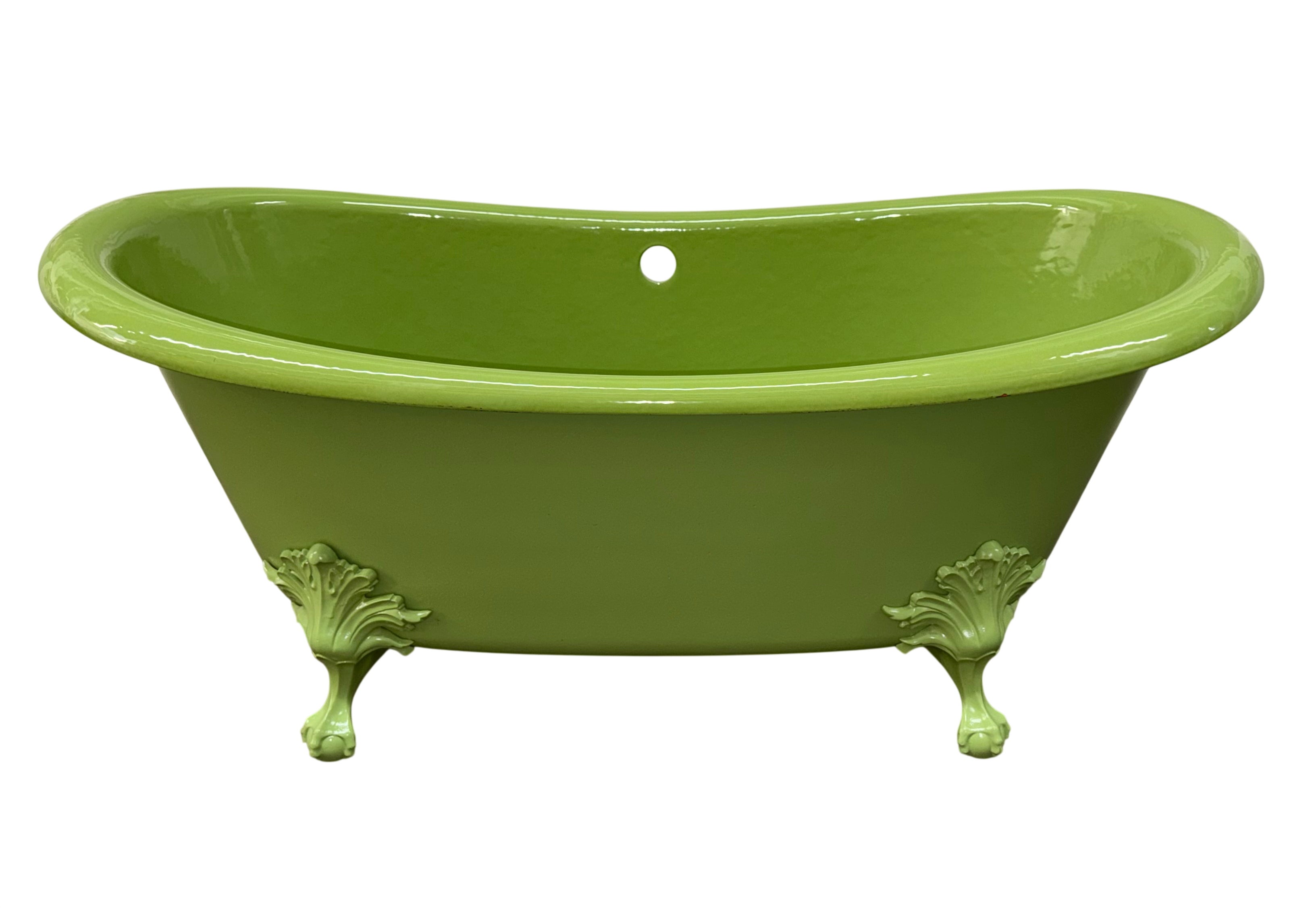 Green bathtub with decorative legs on a gray floor.